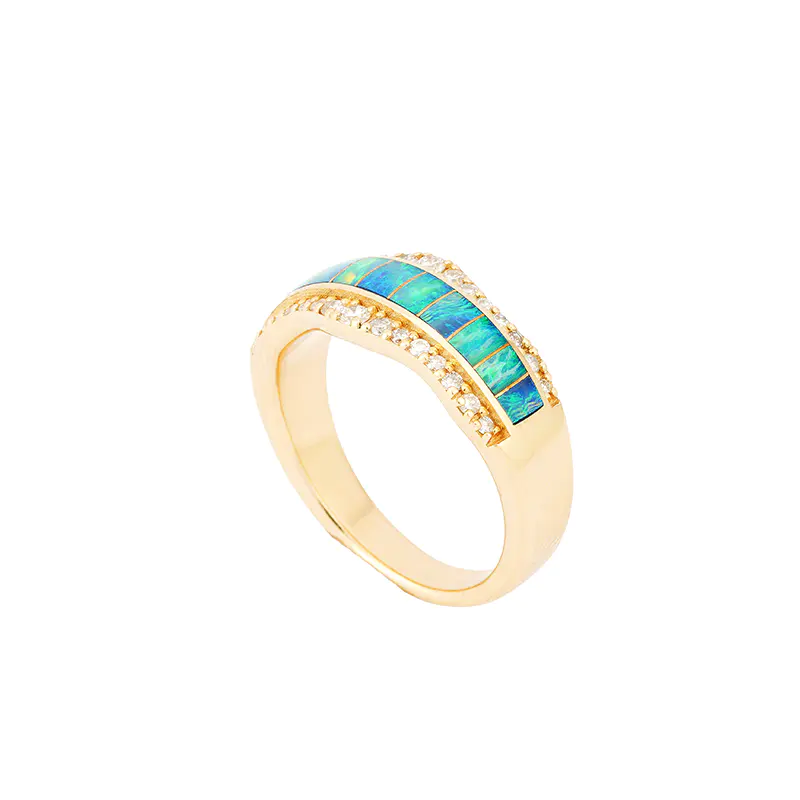 Three-quarter angled view of a 14k gold ring by Navajo jewelry designer Mia Zaara Hamdouni, featuring a segmented blue opal inlay band across the top and a row of pavé-set diamond accents along the curved gold setting.