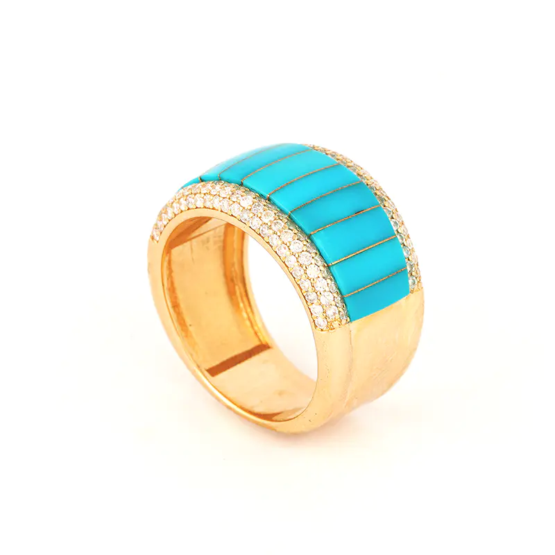 Three-quarter front view of a 14k gold ring by Navajo jewelry designer Mia Zaara Hamdouni, featuring graduated Sleeping Beauty turquoise inlay across the top and rows of pavé diamond accents set into a wide, polished gold band.